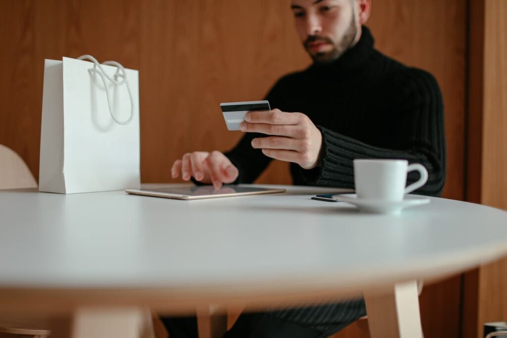 A Man Holding Jayden Wei Portfolio’s Savings Card